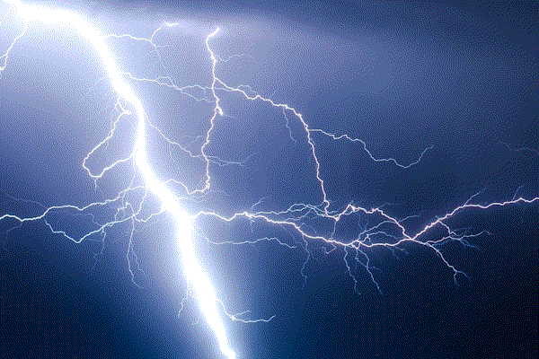Dramatic lightning storm over a dark landscape