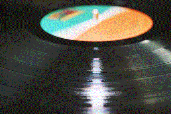 A gold-anodized record mounted on a spacecraft, shining against deep space