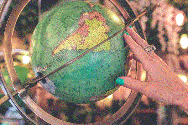 An ornate globe showing the continents in muted colours