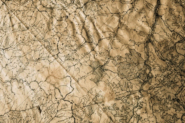 An antique map spread across a weathered wooden table, its edges curling with age